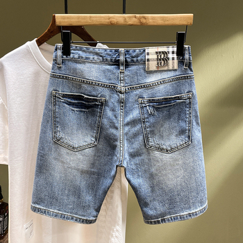 Siuvinėtos džinsinės kelnės su skylutėmis. Vyriškos užsienio prekybos tarpvalstybinio lokomotyvo madingos firminės elastinės, plonos, siuvinėtos kelnės.