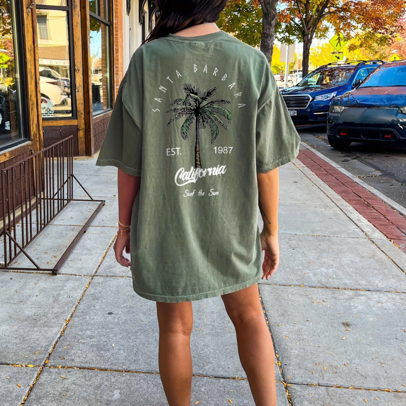 Kerek nyakú, kókuszfa mintás, keresztezett szegélyű pólóruha, tavaszi és nyári lezser, rövid ujjú, fekete női ruházat