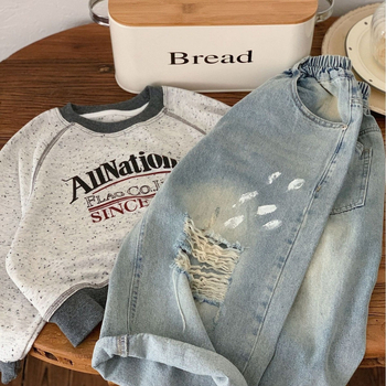 Παιδικά τζιν 2025 Άνοιξη Αγόρια και Κορίτσια Εξατομικευμένα τζιν με σπρέι βαφής, παντελόνια με σκισίματα για μωρά