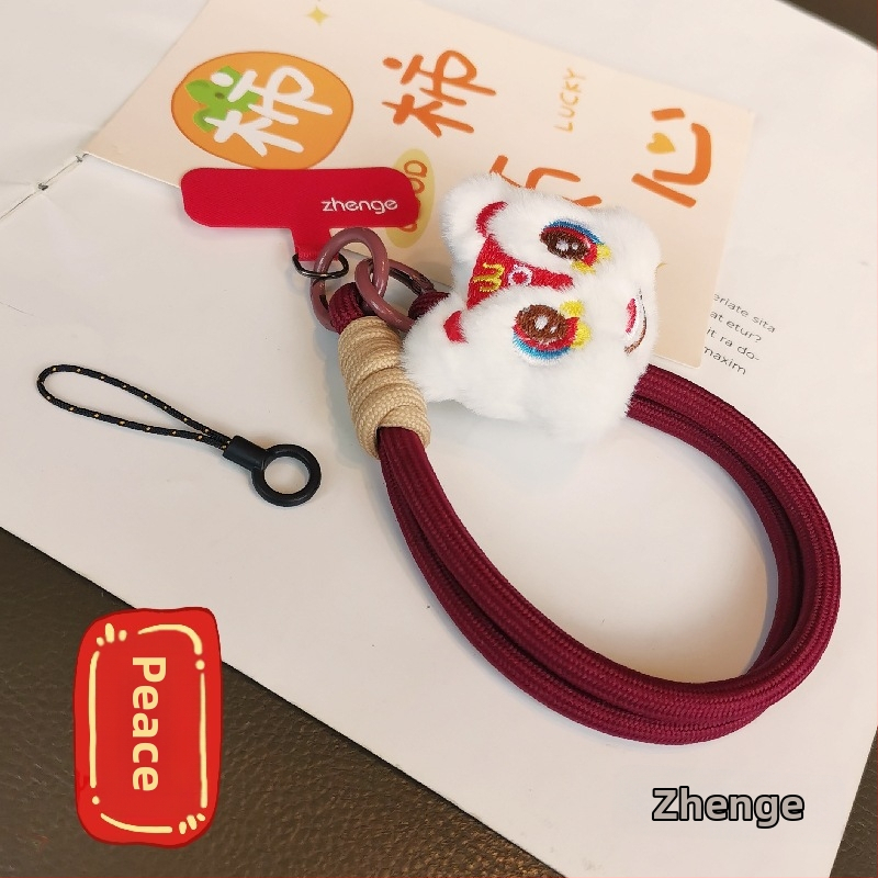 2025 m. prabangios nuotaikos Naujųjų metų raudonas mobiliojo telefono virvelis, mielas pliušinis liūto lėlės pakabukas ant riešo, trumpas
