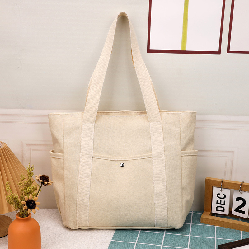 2025 m. naujas didelės talpos drobinis krepšys, skirtas išeiti su gražia išvaizda ir kelionėmis į darbą. Lengviausias pasirinkimas – literatūrinis studentų pečių krepšys, skirtas didmeninei prekybai.