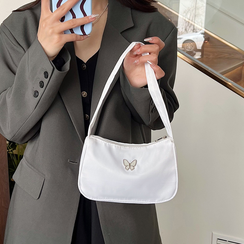 2024. aasta uus lihtne vabaaja käeshoitav väike kott, moodne ja mitmekülgne pendelrännaku õlakott, niši disainiga kaenlaalune kott