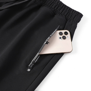 Jarné a jesenné ležérne nohavice pánske voľné nohavice so zaviazanými členkami, pánske tepláky vo veľkých veľkostiach, trendy športové nohavice pre mladých a stredných vekových kategórií.