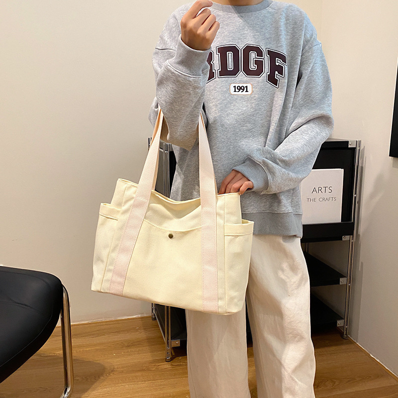 2024. aasta uus lõuendikott, naiste universaalne õlakott, suure mahutavusega raamatutega täidetud õpilase klassiruumi pendeldajakott, uus käekott