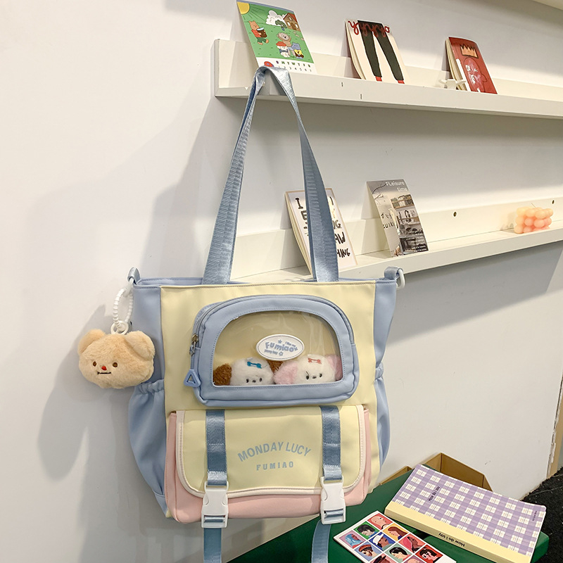 Jauna multfilmu stila bērnu mugursoma, maza, svaiga, jauka, lielas ietilpības skolēnu plecu soma, kas paredzēta došanās uz nodarbībām un skolēnu somu