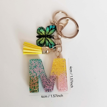 Ristäärisega 26 initsiaali vikerkaare järkjärgulise tutiga liblika ripatsiga võtmehoidja, litritega liimvaigust võtmehoidja