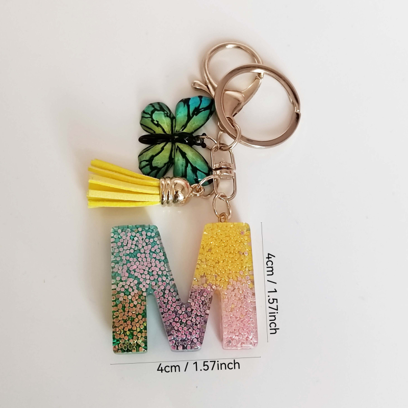 Ristäärisega 26 initsiaali vikerkaare järkjärgulise tutiga liblika ripatsiga võtmehoidja, litritega liimvaigust võtmehoidja