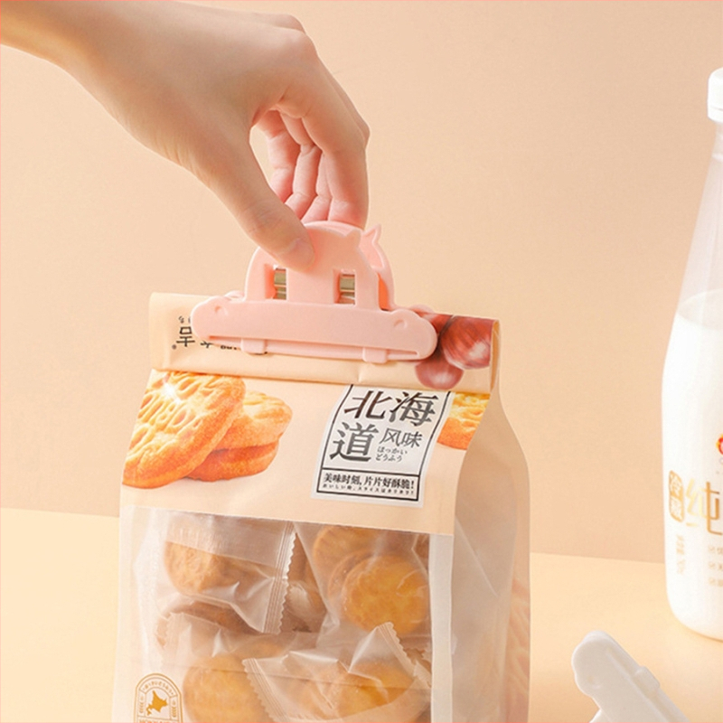 Užkandžių sandarinimo spaustukas didmeninės prekybos maišeliui virtuvės maistui arbatai pieno milteliams plastikinis nešiojamas konservavimas drėgmei atsparus maisto sandarinimo spaustukas