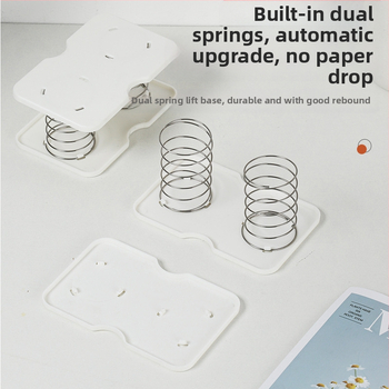 Pakeliama servetėlių dėžutės spyruoklinė atrama, skirta pritraukti prie apatinės spyruoklinės stalčiaus dėžutės apatinės atramos, laikymo dėžutės spyruoklinė lapo pakėlimo elastinė atrama