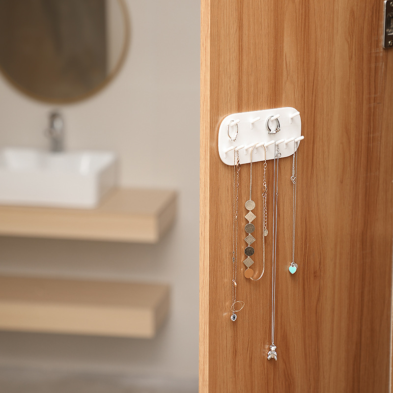 Ehteriiul ilma mulgustamiseta seinale riputatav majapidamiskõrvarõngaste kaelakee hoiuriiul seinale kinnitatav ehete vitriin tehase otsetarnimiseks