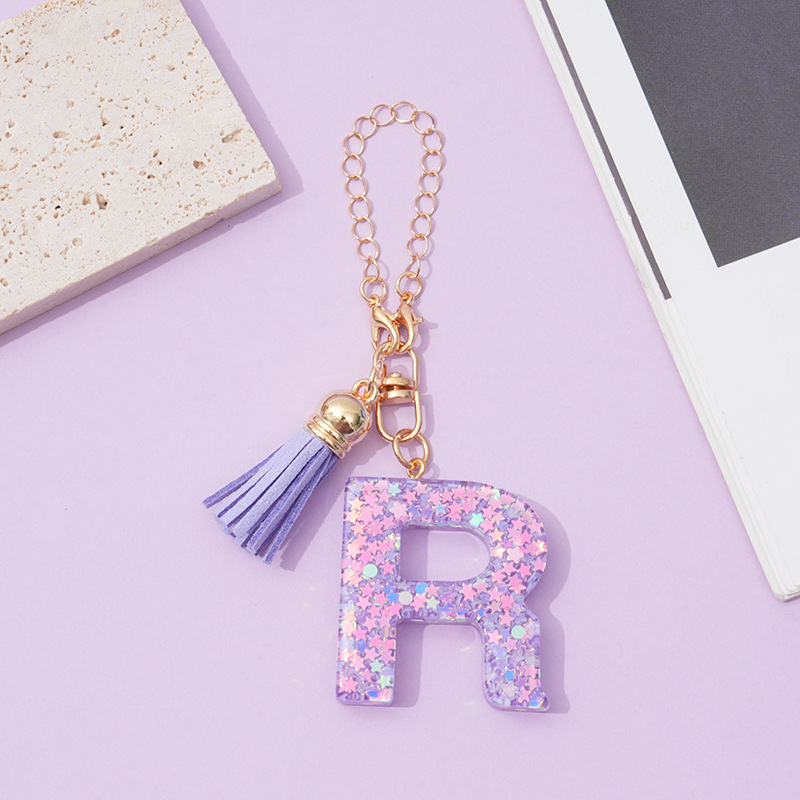 26 angliškų raidžių violetinis kutais ir žvaigždėmis puoštas blizgučiais moteriškas krepšys su vandens puodelio grandinėle, automobilio raktų pakabukas su kryželiu