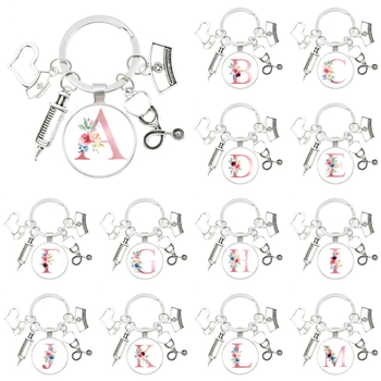 Slaugytojos stetoskopo švirkštas, angliški inicialai nuo A iki Z, raktų pakabukas - medicininis aukso spalvos, skirtas krepšiui ar kuprinei