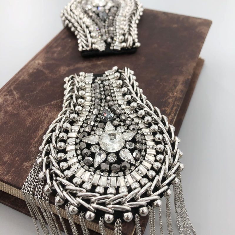 Piiriülesed teemantidega kaetud metallist tutiga õlarihmad, rasketööstuse märgid, riidest pasta, sobivad esitusülikonna isiksused, väliskaubandus, eksport, mehed ja naised