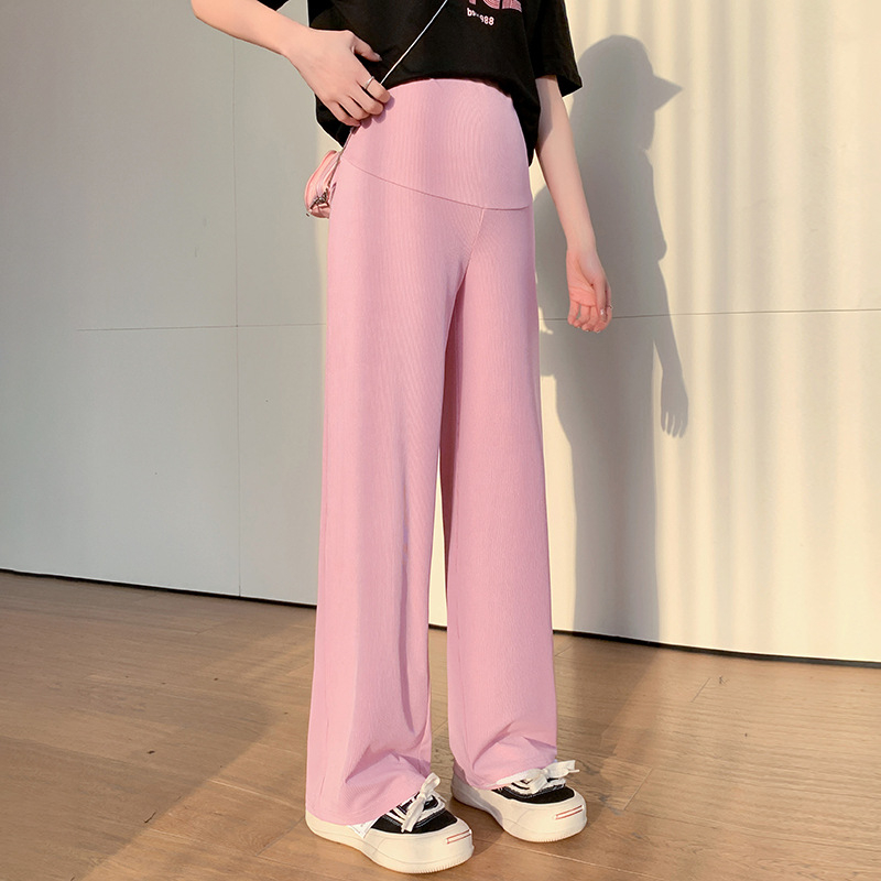 Tikra sandėlyje esančių tamprių, neblunkančių M-3XL nėščiosioms skirtų plačių kelnių nuotrauka. Vasarinės laisvos, laisvos, liekninančios kelnės su vertikaliomis juostelėmis viršutiniams drabužiams.