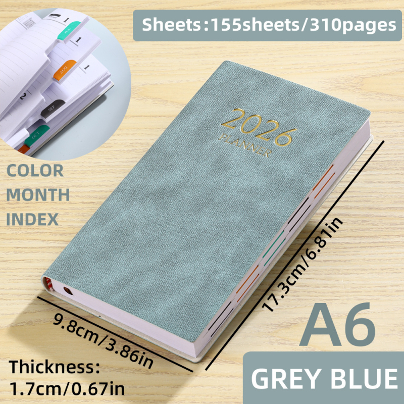 Laos olev 2026. aasta A6 formaadis ingliskeelne planeerija värvilise kuuindeksiga, paksendatud kalendriga, piiriülese teemapäevikuga