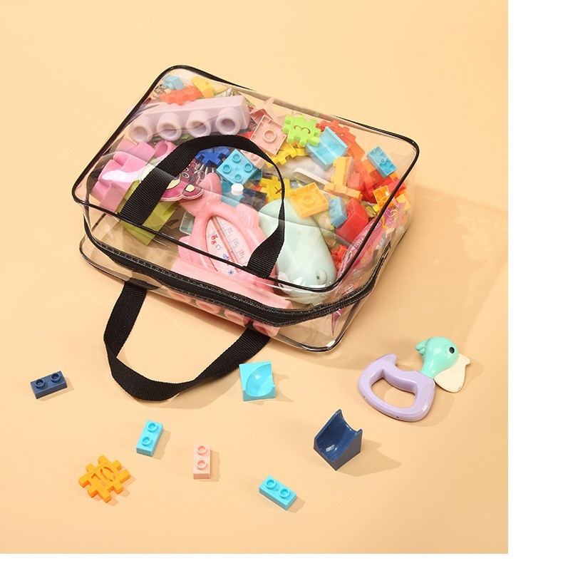 Gyárilag közvetlen nyári átlátszó kozmetikai táska gombokkal, átlátszó PVC gyermekjáték-tároló táska utazó tárolótáska