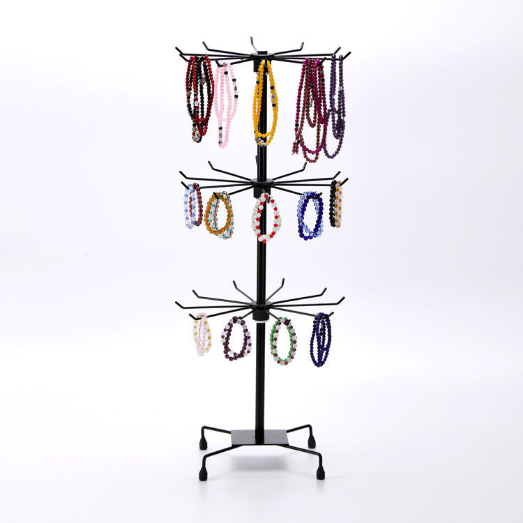 Daugiasluoksnė gatvės prekystalio besisukanti lentynėlė, karoliai, automobiliams pakabinami karoliukai, virvelės, kojinės, skrybėlių papuošalų lentynėlė, parduotuvės durų pakabinamas stovas, vitrina 1