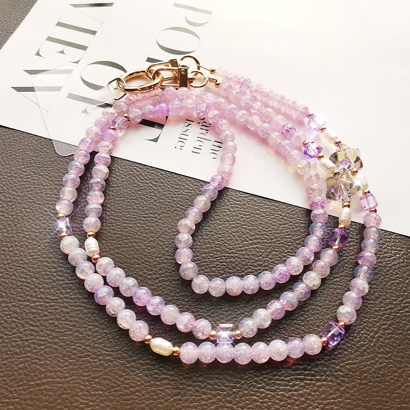 Ilgas mobiliojo telefono dirželis su įtrūkusiais karoliukais, krištolo karoliukų grandinėlė, išskirtinis jūrų žvaigždės karoliukų maišelis su grandinėle, pakabukas mobiliojo telefono dėklui, apsaugantis nuo pametimo.