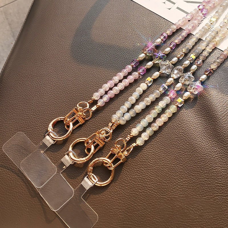 Ilgas mobiliojo telefono dirželis su įtrūkusiais karoliukais, krištolo karoliukų grandinėlė, išskirtinis jūrų žvaigždės karoliukų maišelis su grandinėle, pakabukas mobiliojo telefono dėklui, apsaugantis nuo pametimo.