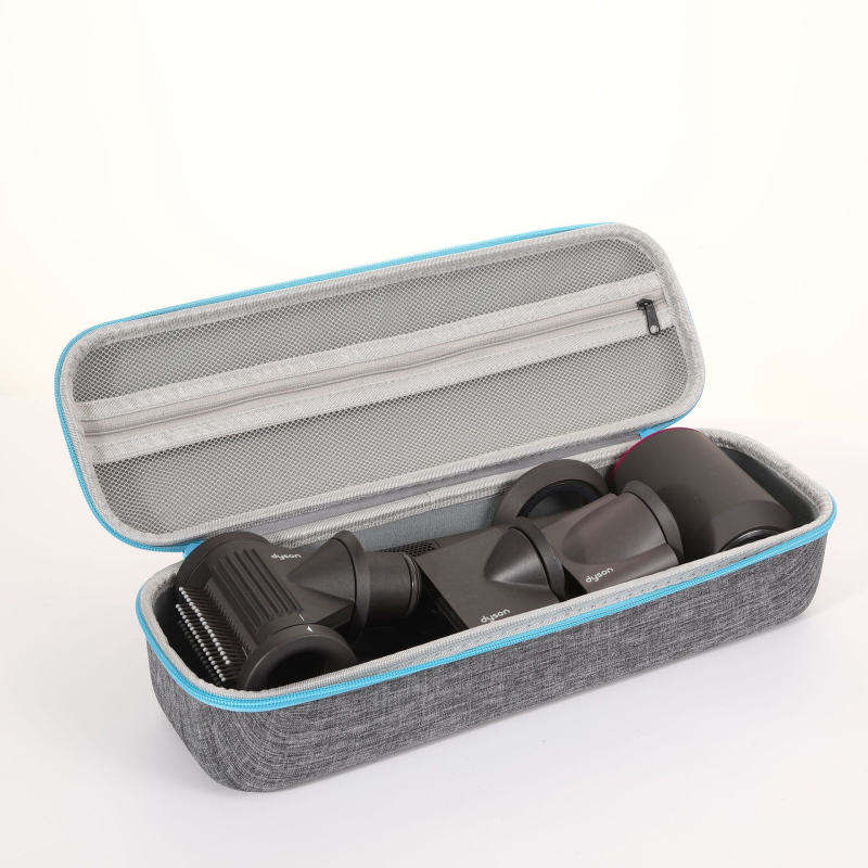 Dysoni fööni hoiukarp, juuksuritööriistade hoiukott, lokitangid, sirgendaja, kukkumisvastane kaitsekott laos.