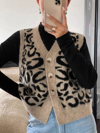 Vesta cardigan tricotat cu imprimeu leopard, decolteu în V, fără mâneci, lungime 50–65 cm, închidere cu nasturi multiple