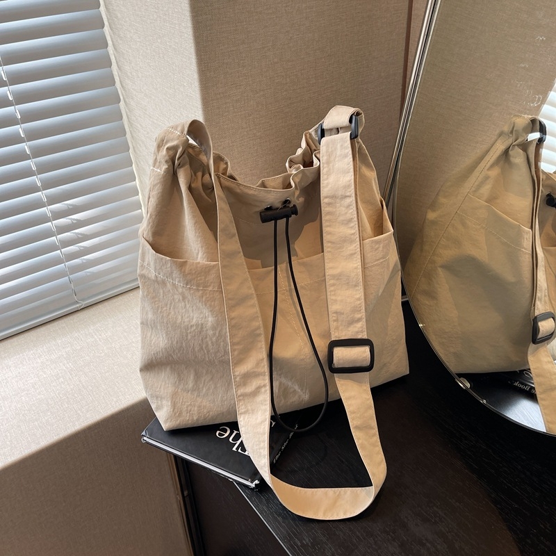 Casual ženska nylon tote torba; vertikalni kvadratni oblik, magnetsko zatvaranje, poliester podstava, unutarnje džepove za telefon i karticu identifikacije.