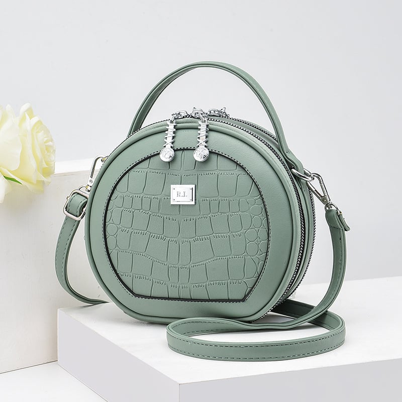 Crossbody taška, malý okrúhly tvar, PU materiál, zips otvorenie, vnútorná kapsa na zips, polyesterová výstelka