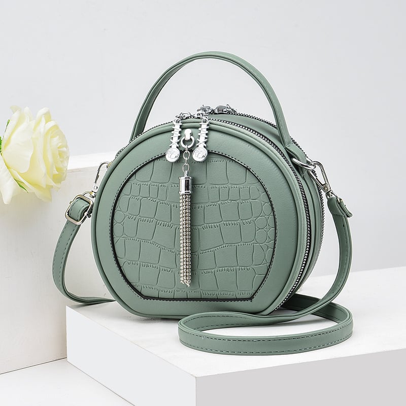 Crossbody taška, malý okrúhly tvar, PU materiál, zips otvorenie, vnútorná kapsa na zips, polyesterová výstelka