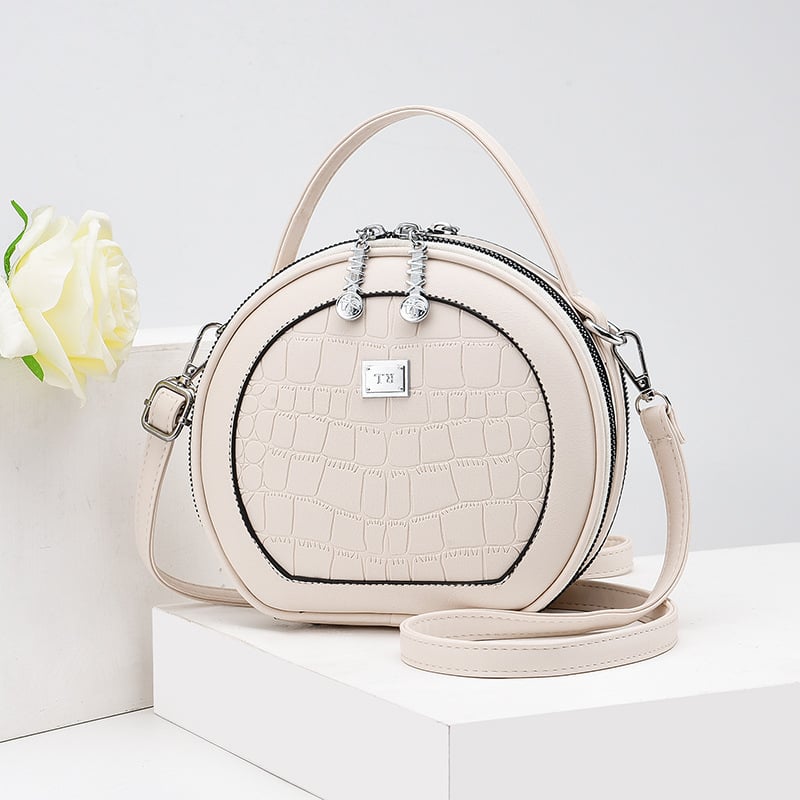 Crossbody taška, malý okrúhly tvar, PU materiál, zips otvorenie, vnútorná kapsa na zips, polyesterová výstelka