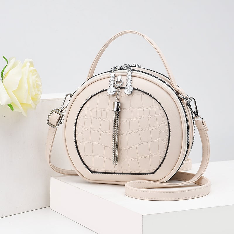 Crossbody taška, malý okrúhly tvar, PU materiál, zips otvorenie, vnútorná kapsa na zips, polyesterová výstelka