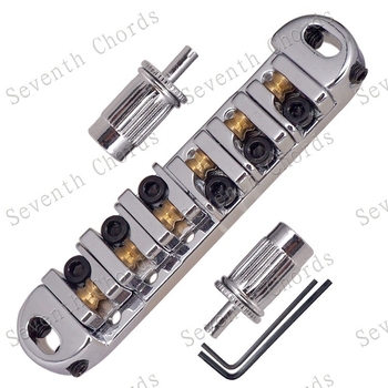 Γέφυρα ηλεκτρικής κιθάρας με κυλίνδρους-μπάλες, πλάκα χορδών και μεγάλες βίδες σύσφιξης; υλικό: κράμα σιδήρου-ψευδάργυρου