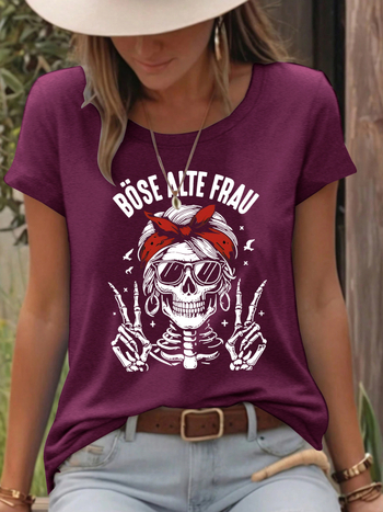 Γυναικείο T‑shirt με εκτύπωση κρανίου, μείγμα πολυεστέρα-βαμβάκι (50–70% πολυεστέρα, 30–50% βαμβάκι), κοντά μανίκια, στρογγυλή λαιμόκοψη, μεσαίο μήκος.