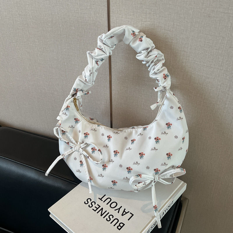 Női vászon táska masnival — dumpling alak, Oxford anyag, cipzáras zárás, poliészter bélés, mobiltelefon rekesz, tavasz 2025