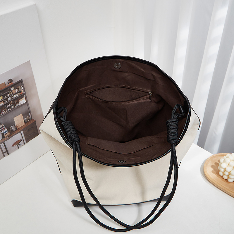 ANNMUU Vászon vödrötáska — városi minimalist stílus, mágneszár, belső cipzáras zseb, telefon- és ID-zseb, függőleges négyszögletű forma