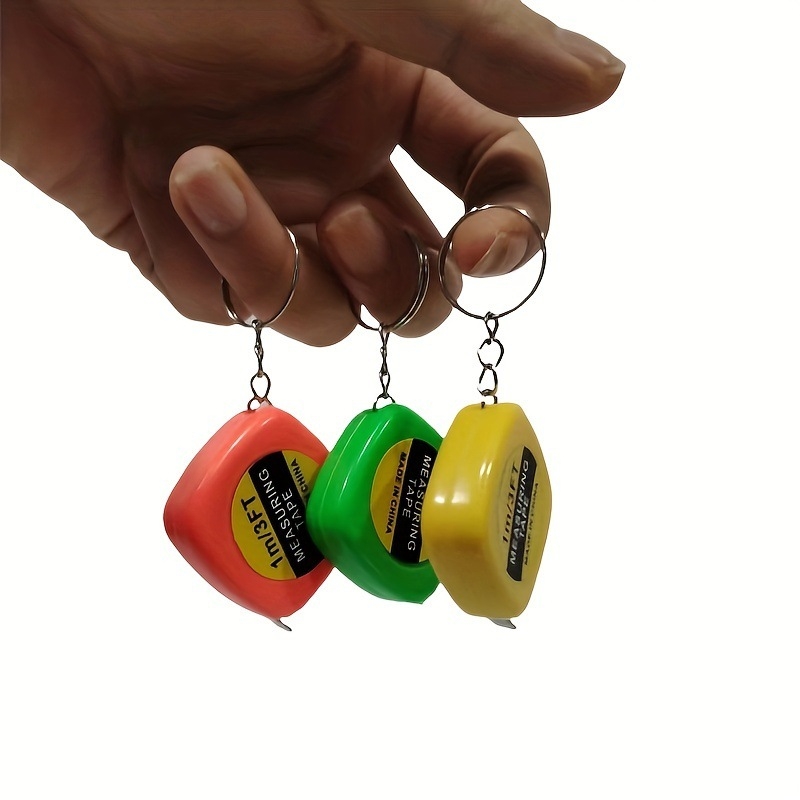 Mini kabatas mērlente apģērbam un ķermeņa apmēriem — pārnēsājams šuvēja mērlente, metāls + plastiks, kvadrātveida forma, apmēram 13 g, drukāts logo, piemērots dāvanai