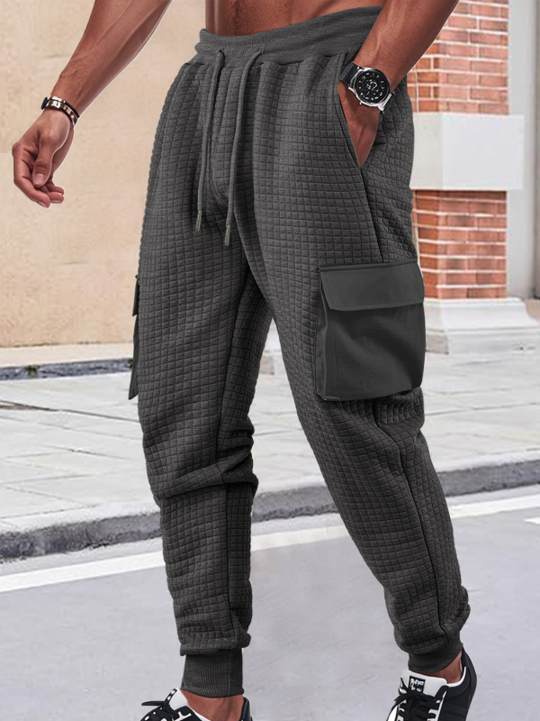 Férfiak szabadidő-munkanadrág, lazán szabott fazon, jacquard apró négyzetek mintázattal, rugalmas poliészter anyag, több zsebbel