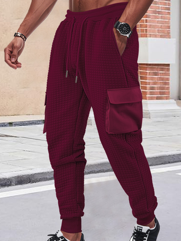 Férfiak szabadidő-munkanadrág, lazán szabott fazon, jacquard apró négyzetek mintázattal, rugalmas poliészter anyag, több zsebbel