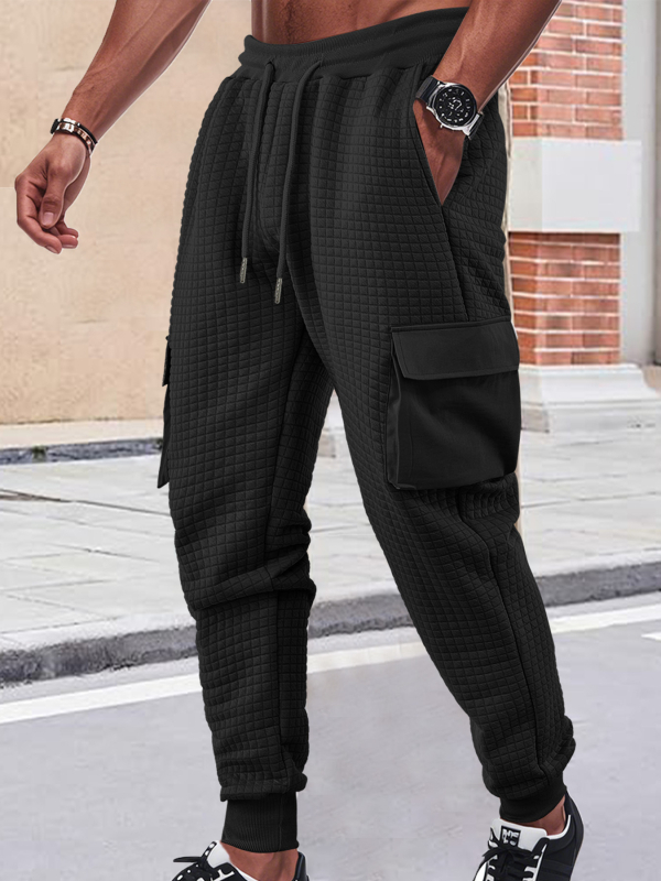 Férfiak szabadidő-munkanadrág, lazán szabott fazon, jacquard apró négyzetek mintázattal, rugalmas poliészter anyag, több zsebbel