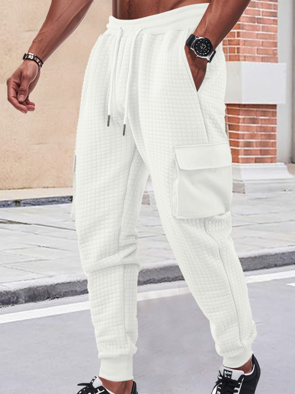 Férfiak szabadidő-munkanadrág, lazán szabott fazon, jacquard apró négyzetek mintázattal, rugalmas poliészter anyag, több zsebbel