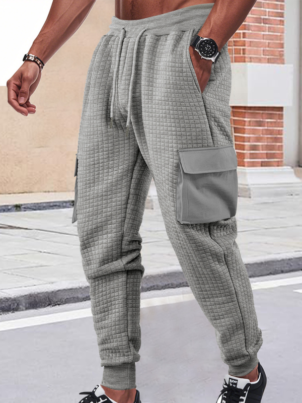 Férfiak szabadidő-munkanadrág, lazán szabott fazon, jacquard apró négyzetek mintázattal, rugalmas poliészter anyag, több zsebbel