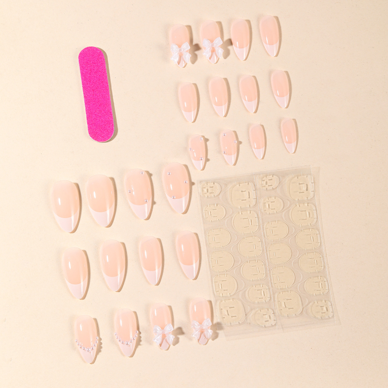 Mandulavágású francia stílusú köröm matrica, gyöngyös és masnis minta nőknek