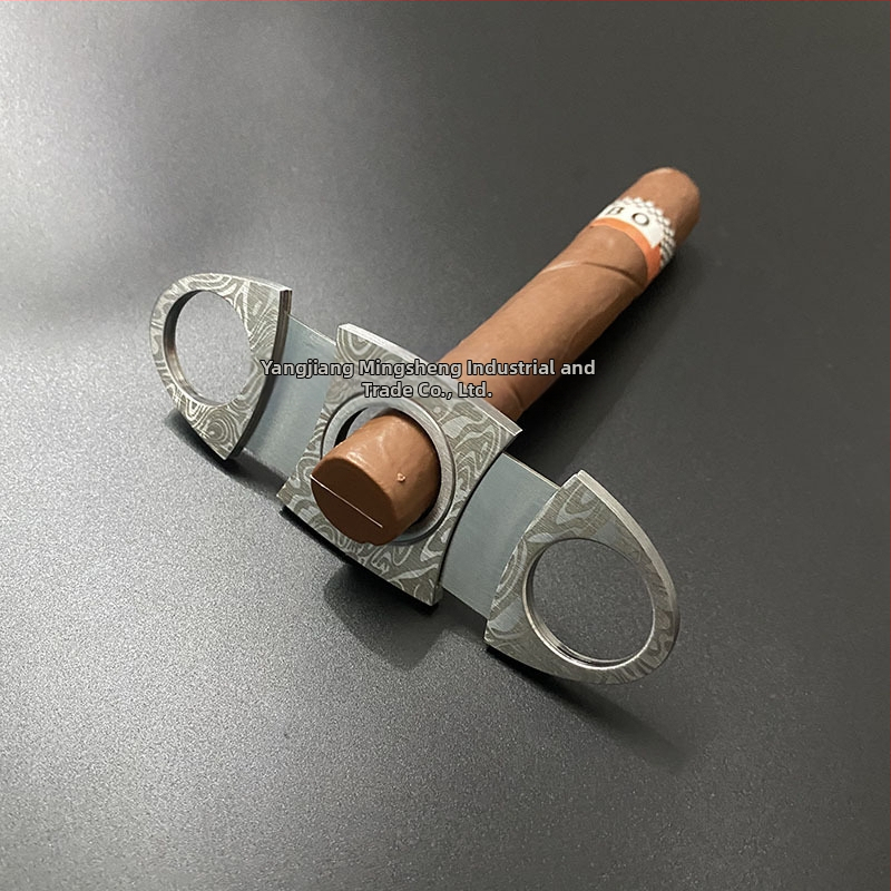 Cigares griezējs no nerūsējoša tērauda ar reljefa rakstu, dubulta asa, pārnēsājams (nerūsējošs tērauds; reljefa raksts; dubulta asa)