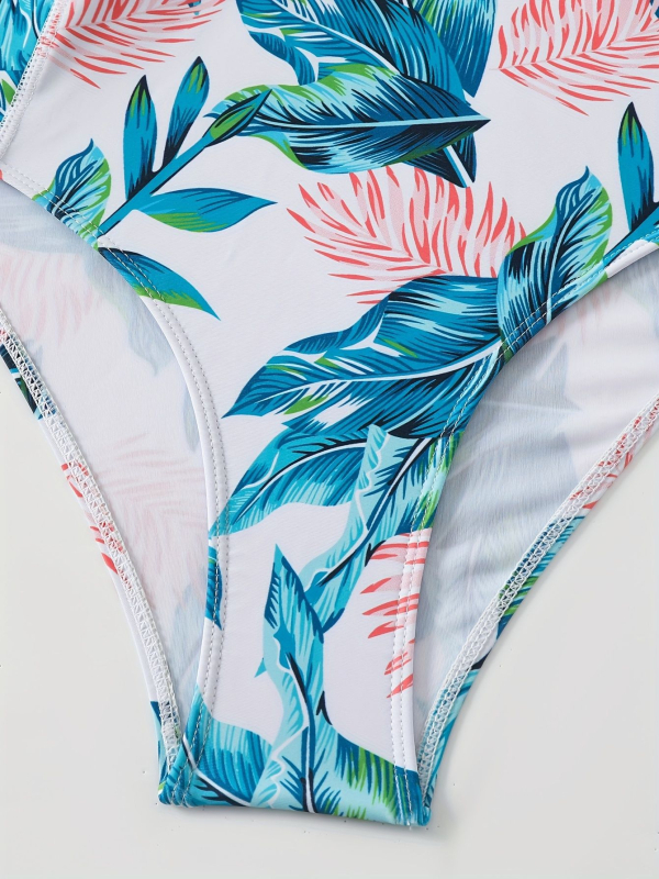 Női egyrészes úszódressz hosszú ujjú cipzárral, vízálló, szorosan illeszkedő; mintás print; anyag poliészter és elasztán 82%-os elasztántartalommal, bélés poliészter