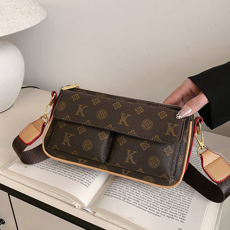 PU anyagú vállra akasztható táska, horizontális négyszögletes forma, cipzáras záródás, belső: cipzárral záródó rejtett zseb és telefontartó zseb, poliészter bélés