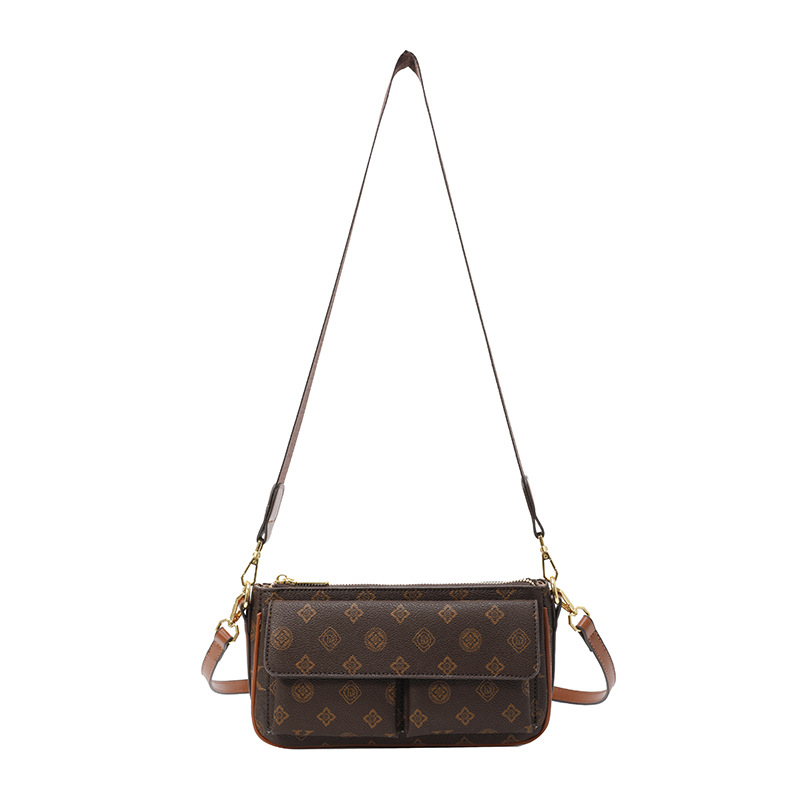 PU anyagú vállra akasztható táska, horizontális négyszögletes forma, cipzáras záródás, belső: cipzárral záródó rejtett zseb és telefontartó zseb, poliészter bélés