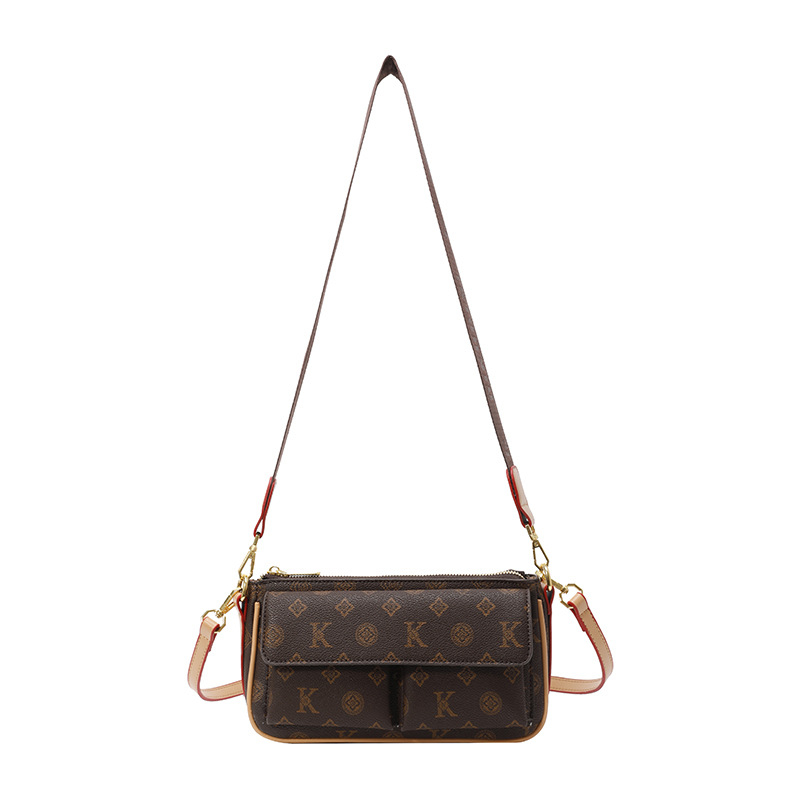 PU anyagú vállra akasztható táska, horizontális négyszögletes forma, cipzáras záródás, belső: cipzárral záródó rejtett zseb és telefontartó zseb, poliészter bélés