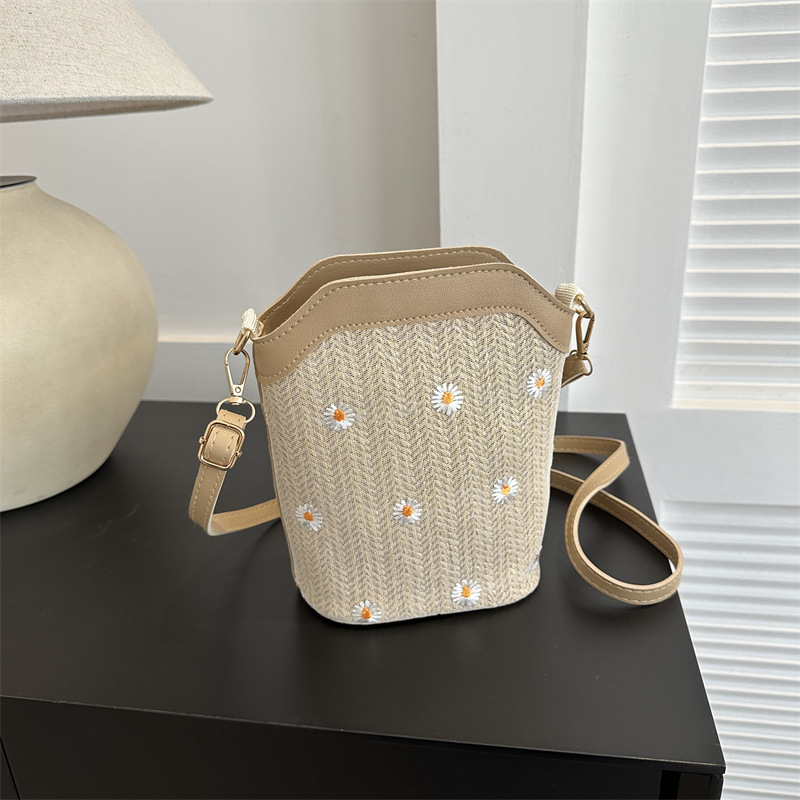 Bucket bag with rope braid material, zipper opening, bucket silhouette, internal cellphone pocket, inner patch pocket