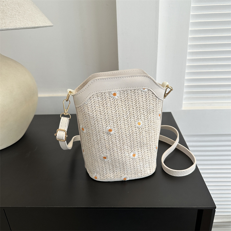 Bucket bag with rope braid material, zipper opening, bucket silhouette, internal cellphone pocket, inner patch pocket