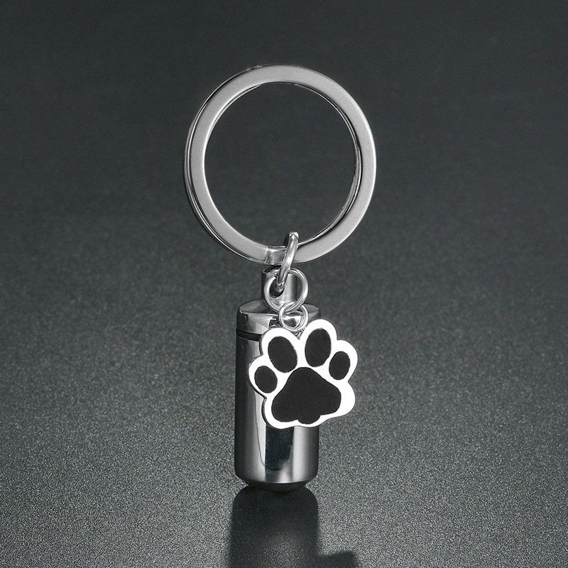 Rozsdamentes acél kulcstartó kapszula medve mancs formájú mintával, nyitható