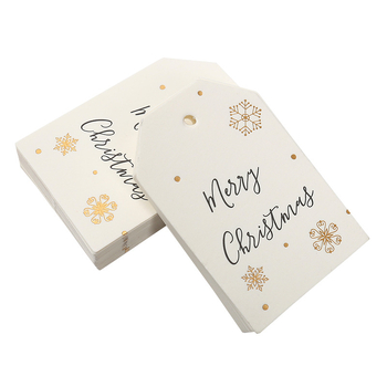 Kalėdinė dovanos etiketė su bronziniu įspaudu ant popierinės kortelės, su užrašu Merry Christmas ir snaigės dizainu
